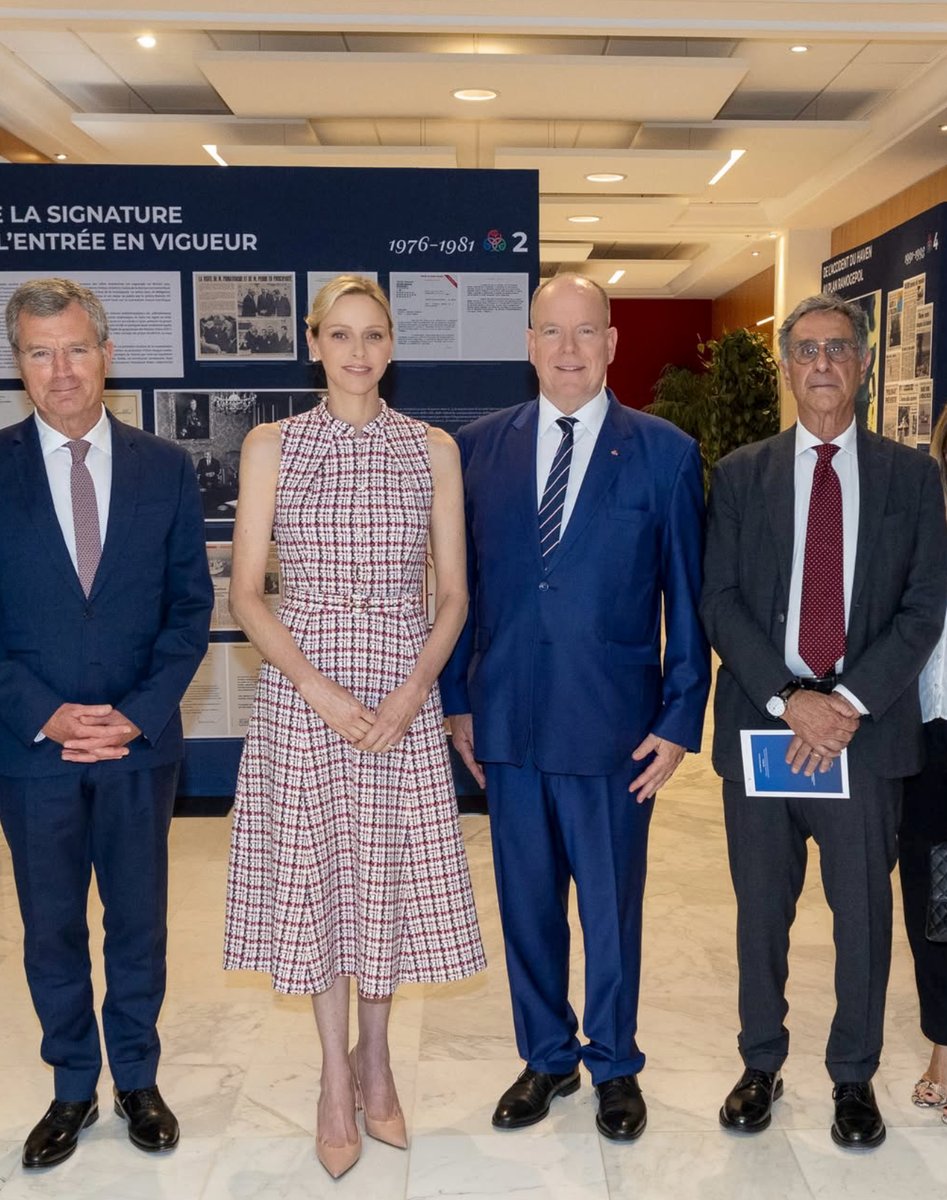 Princess Charlene and Prince Albert listened intently as officials escorted the royal couple through the commemorative RAMOGE exhibition at Monaco's Ministry of State.