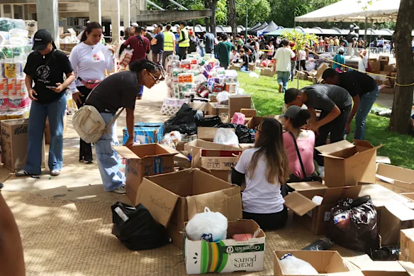 Volunteers categorize donations at the collection center.