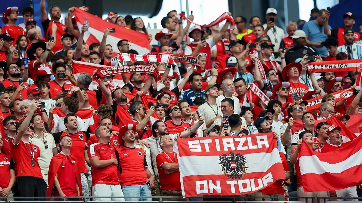 Austrian fans cheer at Dallas Stadium during the 2026 FIFA World Cup match.