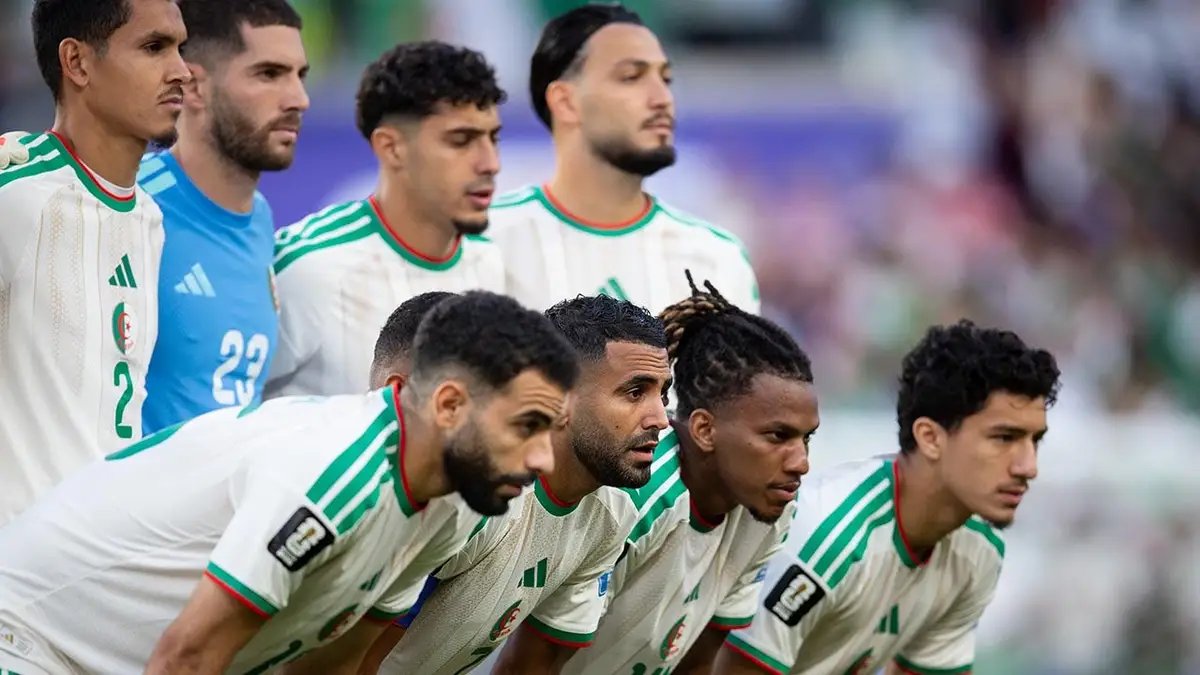 Riyad Mahrez and the Algerian starting line-up pose on the pitch before the 2026 FIFA World Cup match in Santa Clara.