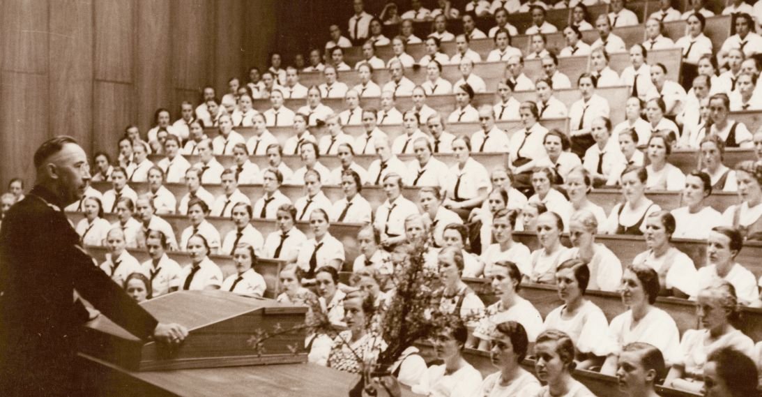 SS Chief Heinrich Himmler addresses a group of women from the Hitler Youth in 1937.
