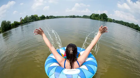 Uetze: A young woman bathes with a swimming ring in Lake Irenen.