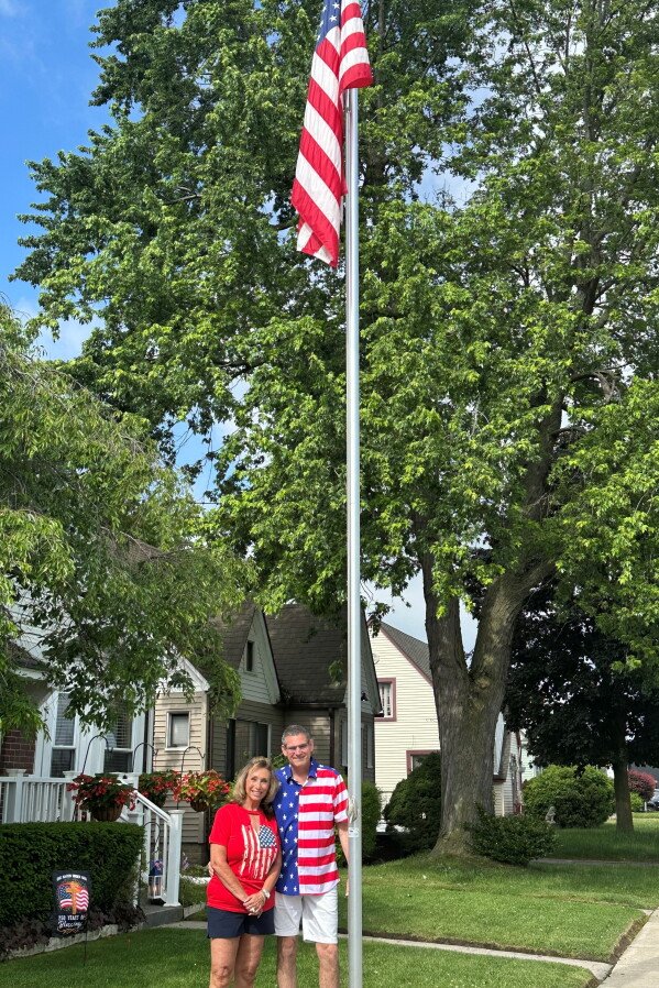The AP-NORC poll shows differing views on what the American flag means. 13 Linda and Greg Cunningham fly an American flag outside their home in Pontiac, Michigan, on June 10, 2026. (AP Photo/Corey R. Williams)