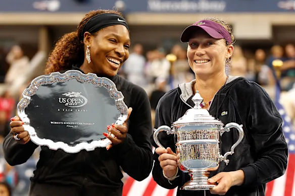 Sam Stosur celebrates the championship trophy with Serena Williams after the women's singles final match at the 2011 US Open.