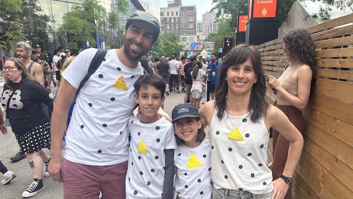 A father, mother and their two children pose in Angina de Poitrine-themed T-shirts. 