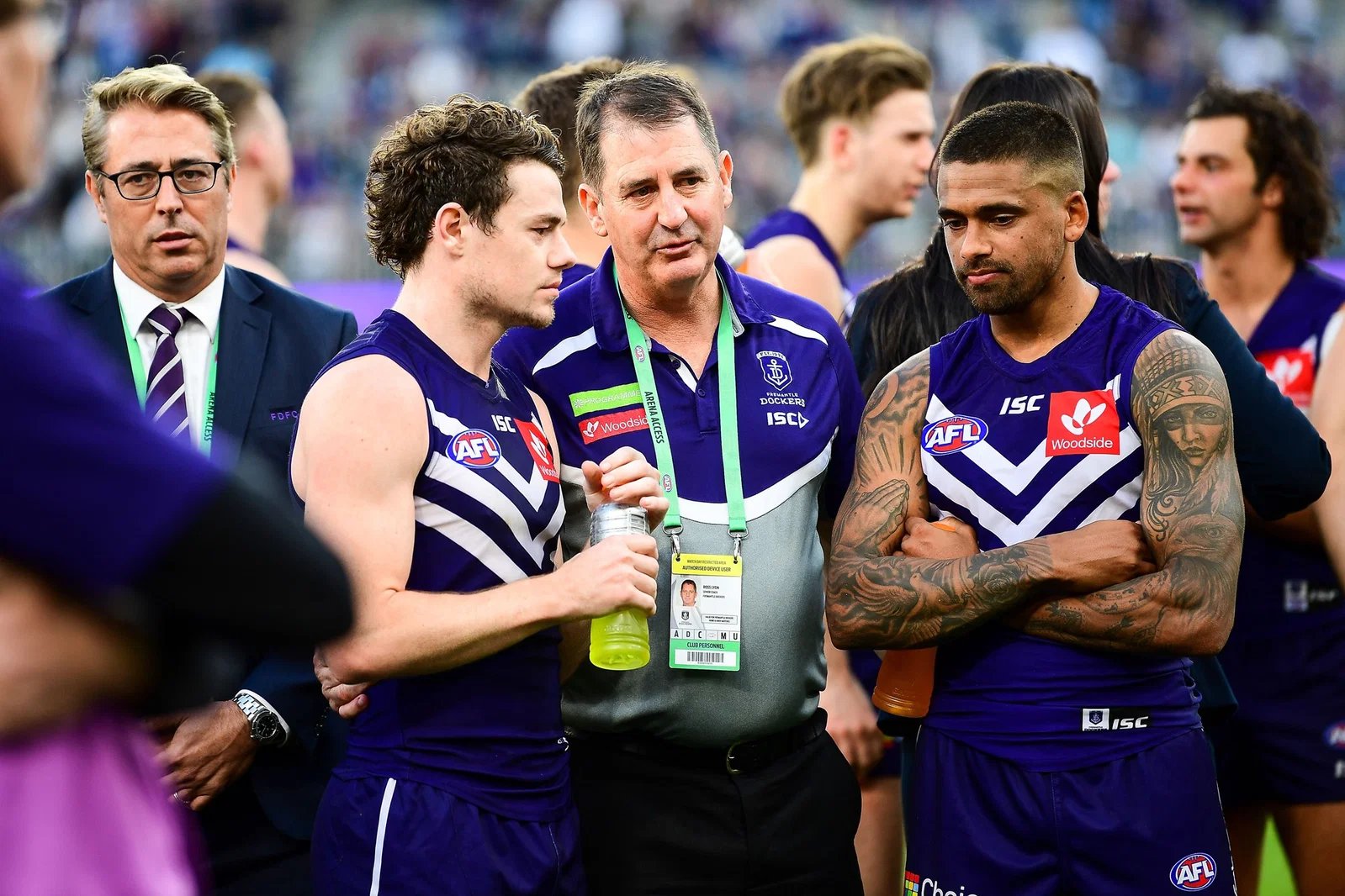   Ross Lyon, Dockers coach, speaks to Lachie Neil and Bradley Hill after the defeat during the 2018 AFL Round 23 match between Fremantle Dockers and Collingwood Magpies at Perth Stadium on August 25, 2018 in Perth, Australia.