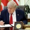 US President Donald Trump signs a decree at the White House.