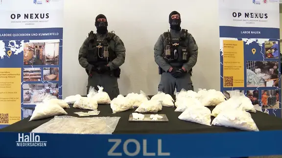 Customs officers guard the seized drugs. | Screenshot Customs officers guard the seized drugs.