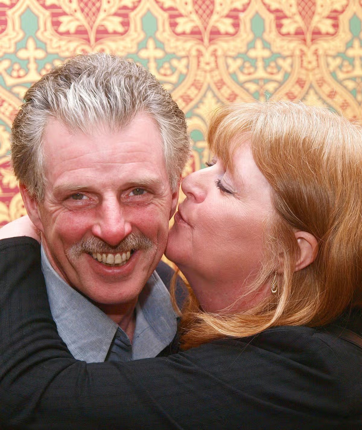 He served 18 years for the murder of his pregnant wife, but still maintains his innocence. 19 Eddie Guilfoyle is pictured being kissed by his late sister Susan Caddick.
