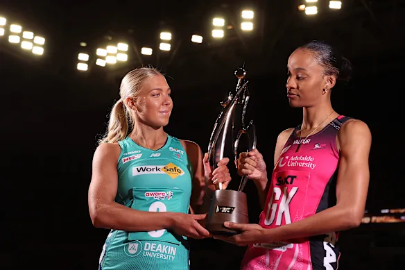 Vixens captain Kate Moloney and Thunderbirds captain Shamera Stirling-Humphrey keep an eye on the Super Netball trophy ahead of Saturday's grand final.