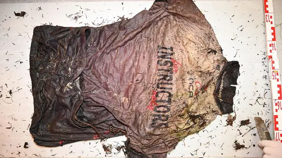 As evidence, there is a dead man's T-shirt on the table: 