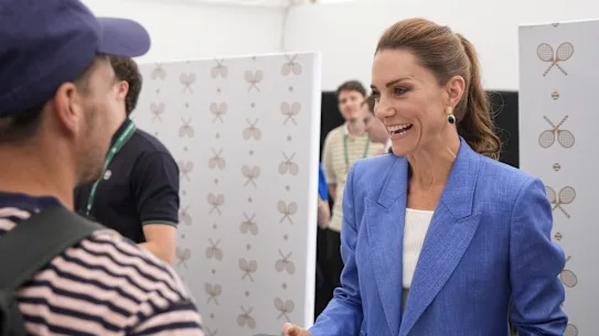Kate sold tickets to tennis fans and took pictures with those standing in line.