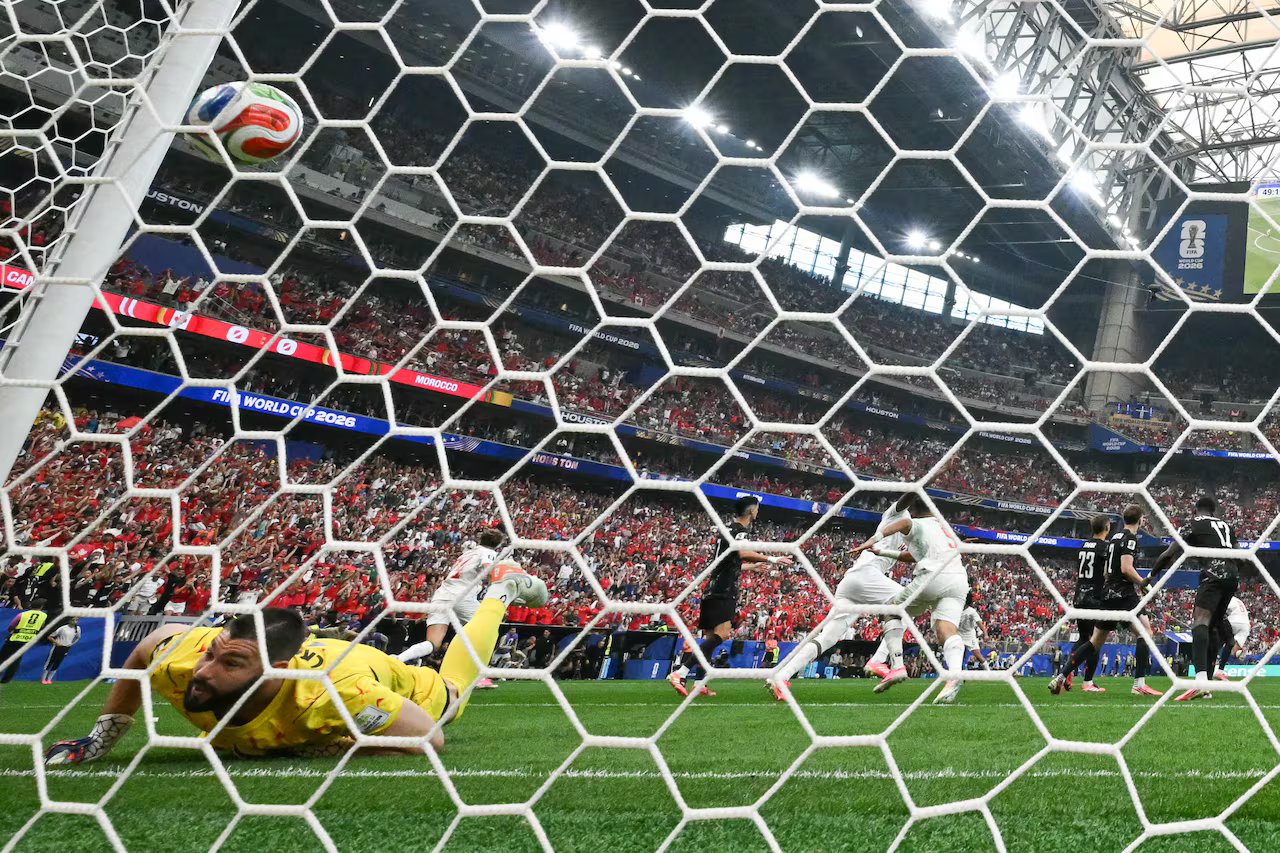 A football goalkeeper is trying to save himself.