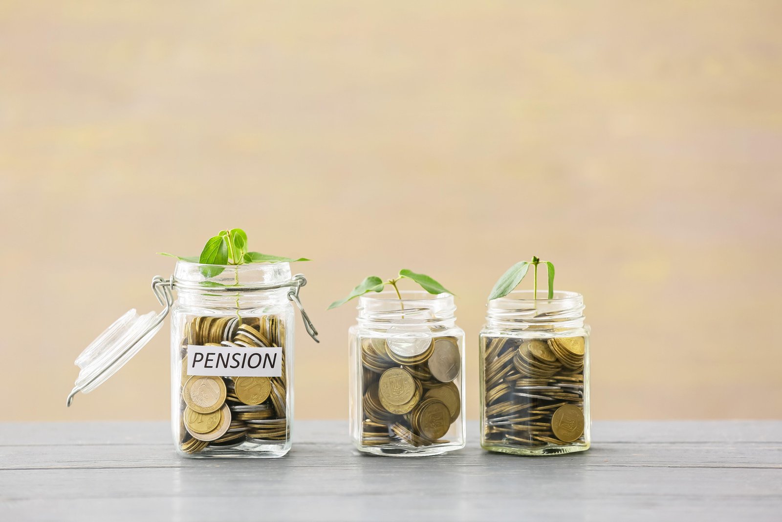 Three glass jars with coins with the inscription 