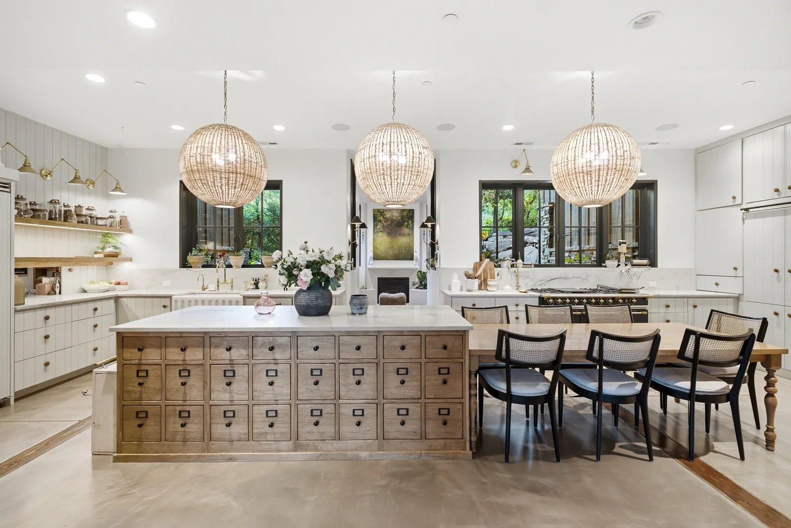 Katherine Heigl has put her 25-acre estate in the Utah mountains up for sale for $10.6 million. 13 white kitchen in Katherine Higgles Utah home with three large round white pendants above the large kitchen island attached to...