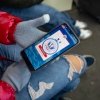 A person tries to use the CBP One app on their phone.