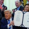 President Trump holds the immigration enforcement funding bill after signing it in the Oval Office of the White House, Wednesday, June 10, 2026, in Washington. 
