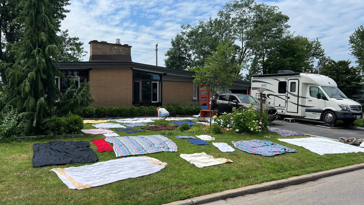 Bed linen is drying on the lawn.