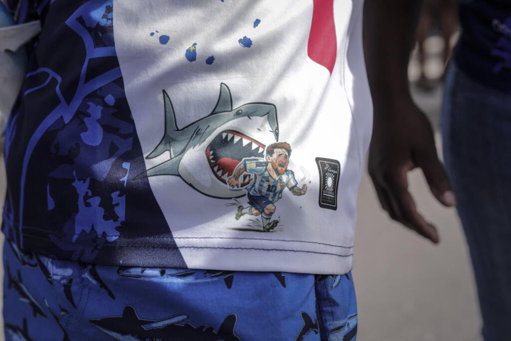Cape Verde's euphoric homecoming after completing a heroic World Cup race 16 A Cape Verdean fan wears an outfit depicting Argentina's Lionel Messi being chased by a shark during celebrations in Praia.