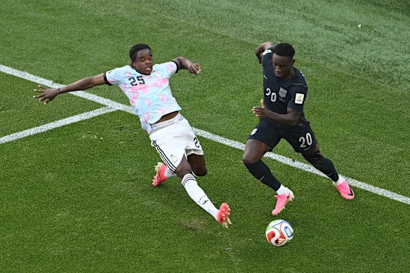 American World Cup star Folarin Balogun (right) and Belgian Nathan Ngoy compete for the ball. The Americans lost and were eliminated from the tournament.