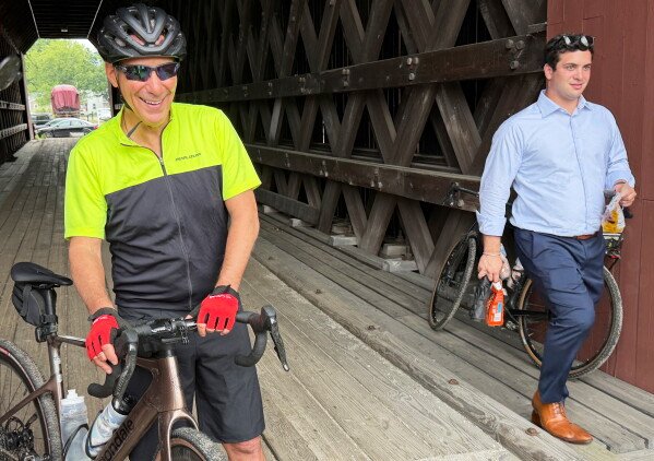 Rahm Emanuel takes a break from a bike ride in New Hampshire, Saturday, June 6, 2026. (AP Photo/Steven Sloan)
