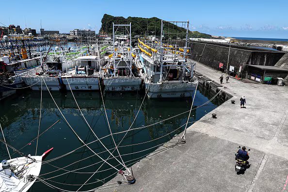 Fishing boats are tied to a pier in the harbor in anticipation of a typhoon.