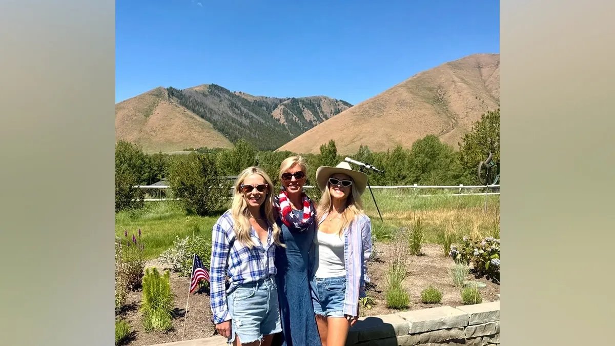 Ali Larter Celebrates the Fourth of July with a Mountain Getaway in Idaho 21 Ali Larter poses with two friends against a mountainous backdrop wearing denim shorts, a white tank top, a striped button-down shirt and a white cowboy hat.