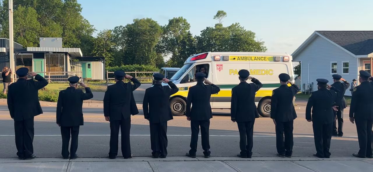 Firefighters greet Jenna Croucher's procession as it enters her hometown of Souris, Pennsylvania, on Friday.