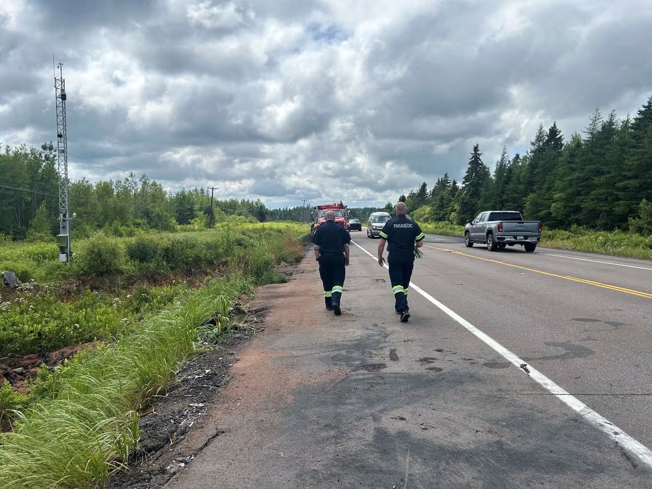 The procession carrying PEI paramedics Mike McKenzie and Jenna Croucher home to the island passes the site where the two died in a two-vehicle crash July 7 in Melrose, Nebraska.