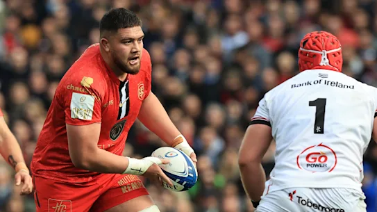 Meafu attacks with the ball for Toulouse.