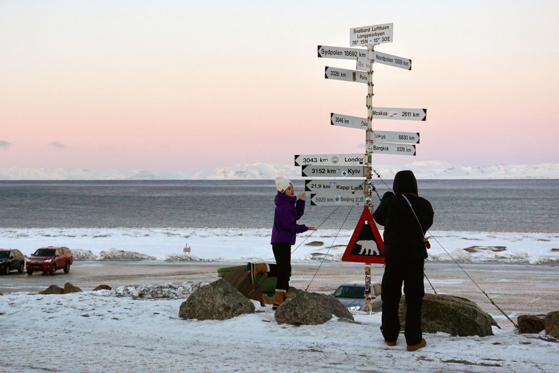 Tensions run high over remote Arctic territory - and it's not Greenland 18 Tourists take photos in front of signs located at Longyearbyen Airport in the Norwegian archipelago of Spitsbergen.