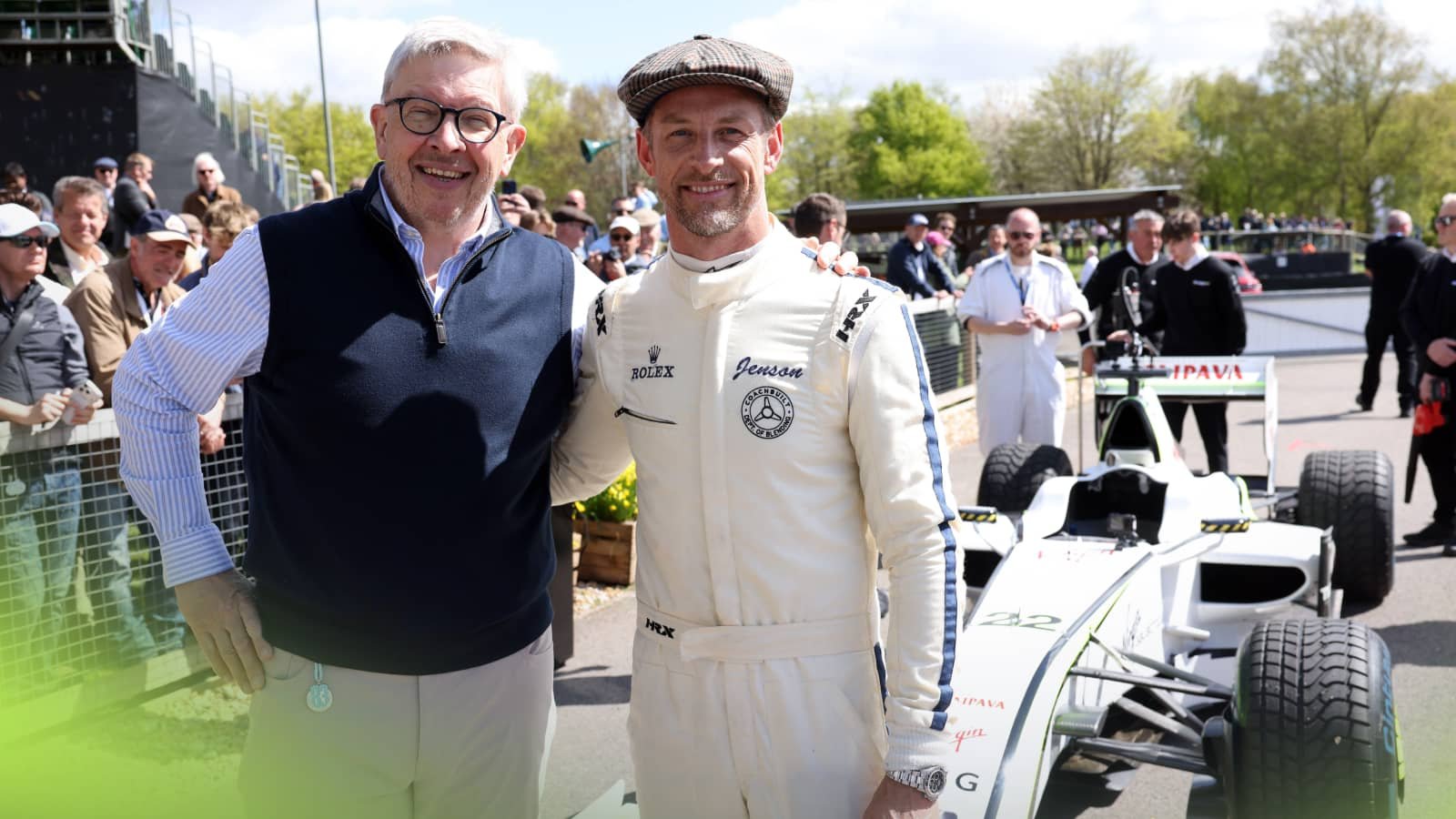 Ross Brawn and Jenson Button pose hand in hand in front of the Brawn GP 001 at Goodwood.