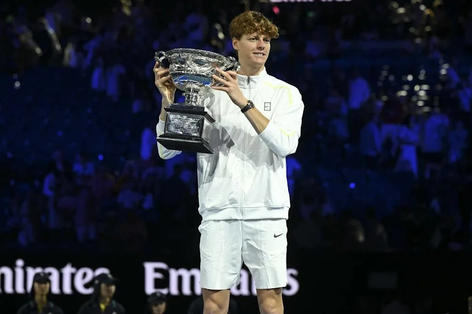 Jannik Sinner of Italy holds the Norman Brookes Challenge Cup after winning the men's singles final at the Australian Open.