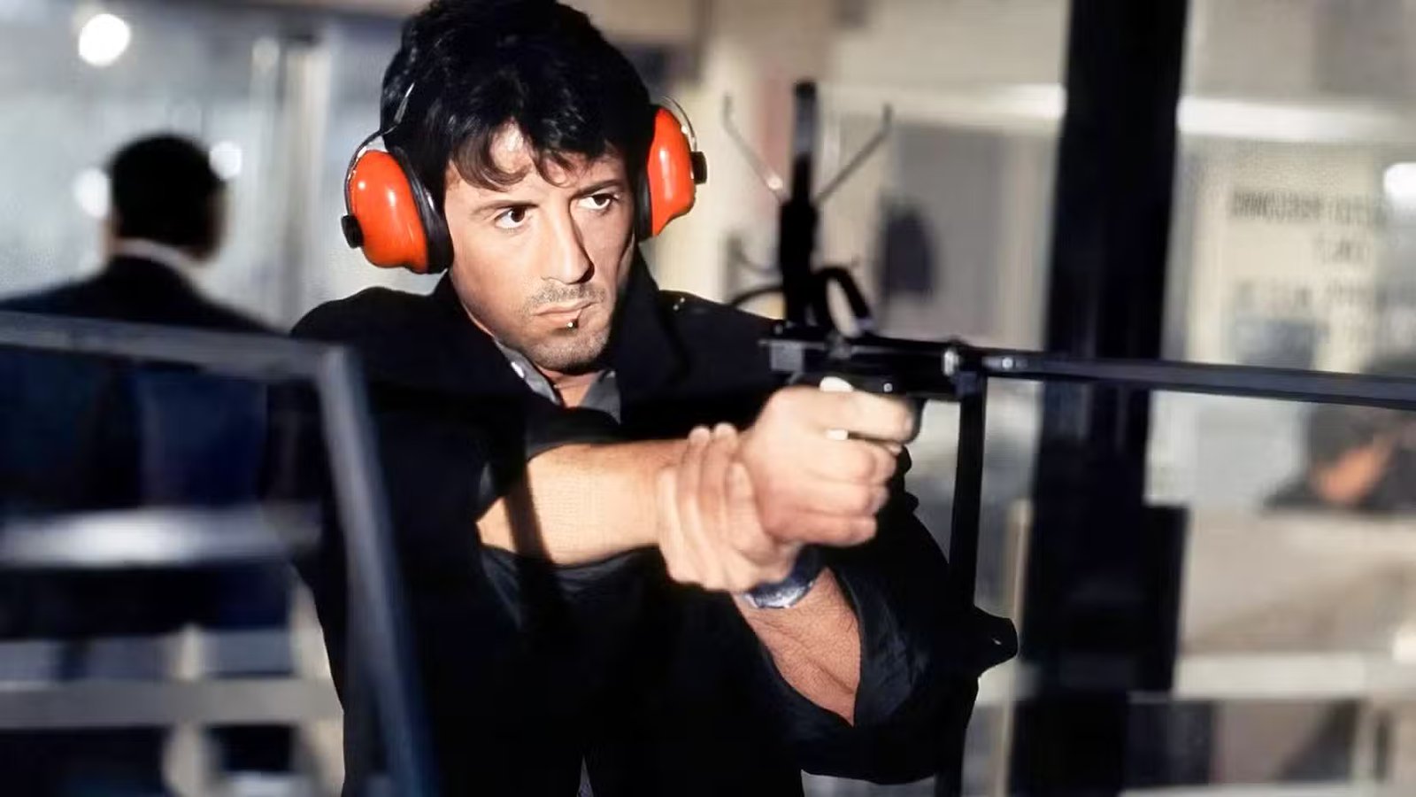 Cobra (Sylvester Stallone) shoots a gun in the movie 