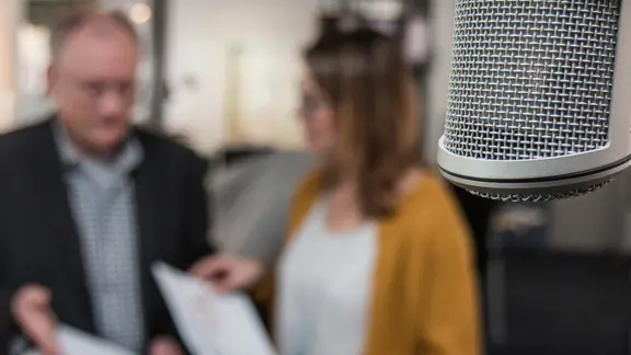 Microphone in front of two people.