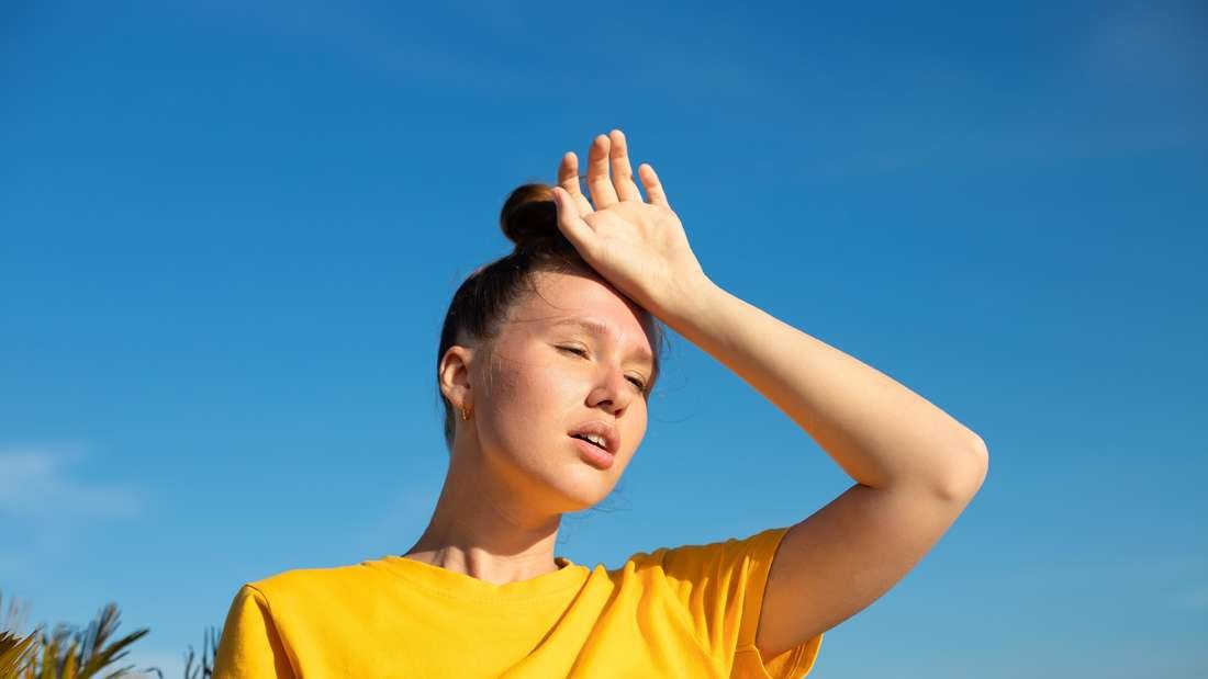 Woman holding her hand behind her head