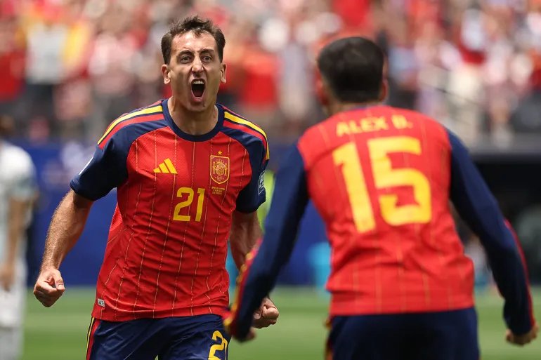 Mikel Oyarzabal (left) celebrates scoring his team's first goal in the round of 16 match between Spain and Austria.