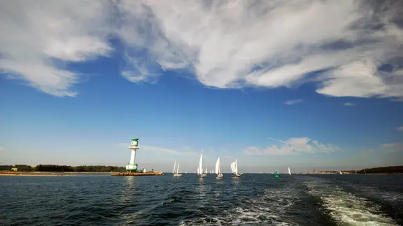 Sailing boats on the Kiel Fjord, clouds overhead.