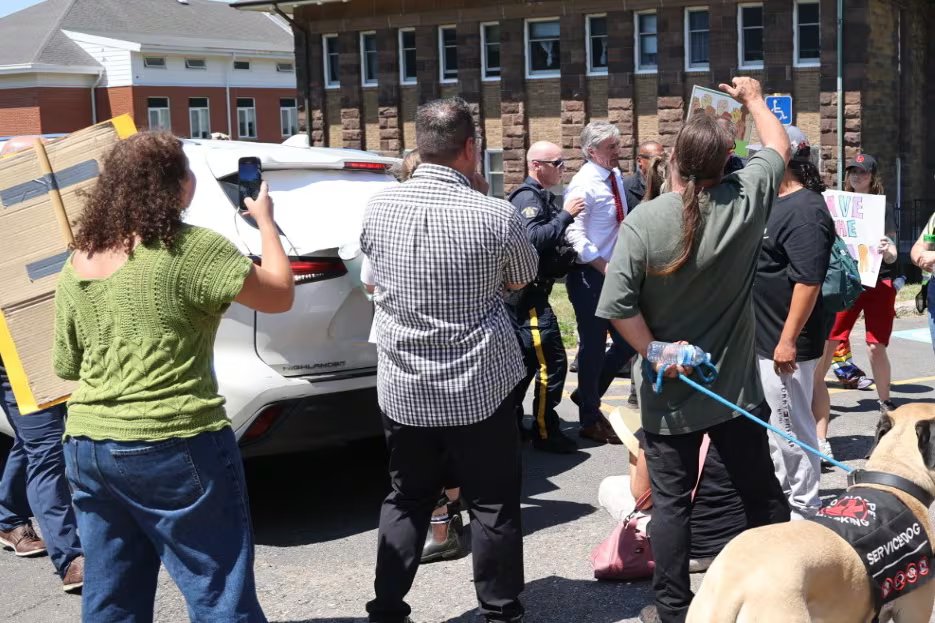 A man being led by a policeman