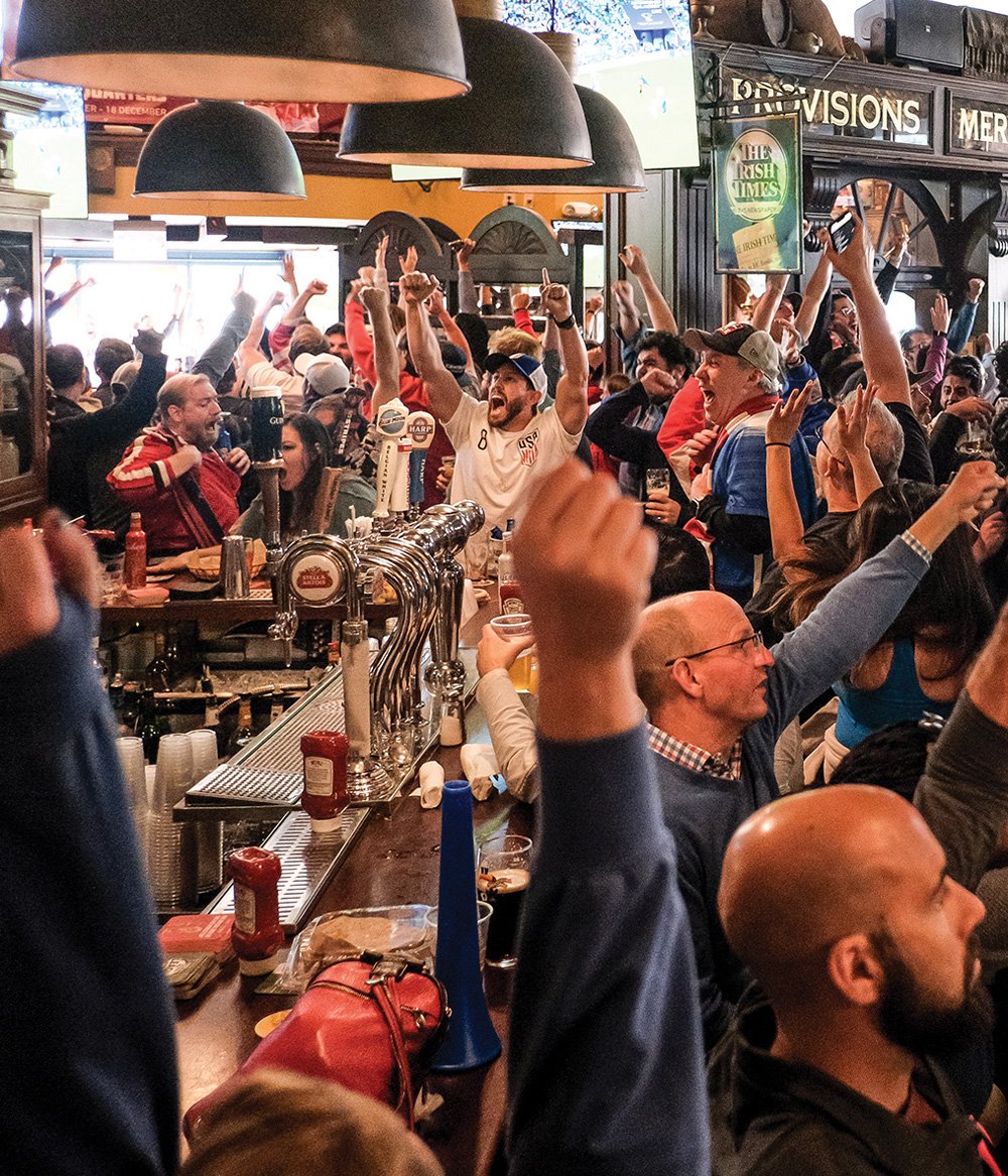 people celebrating in Fado's Irish pub