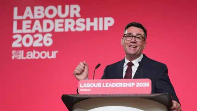 Andy Burnham speaking at the lectern