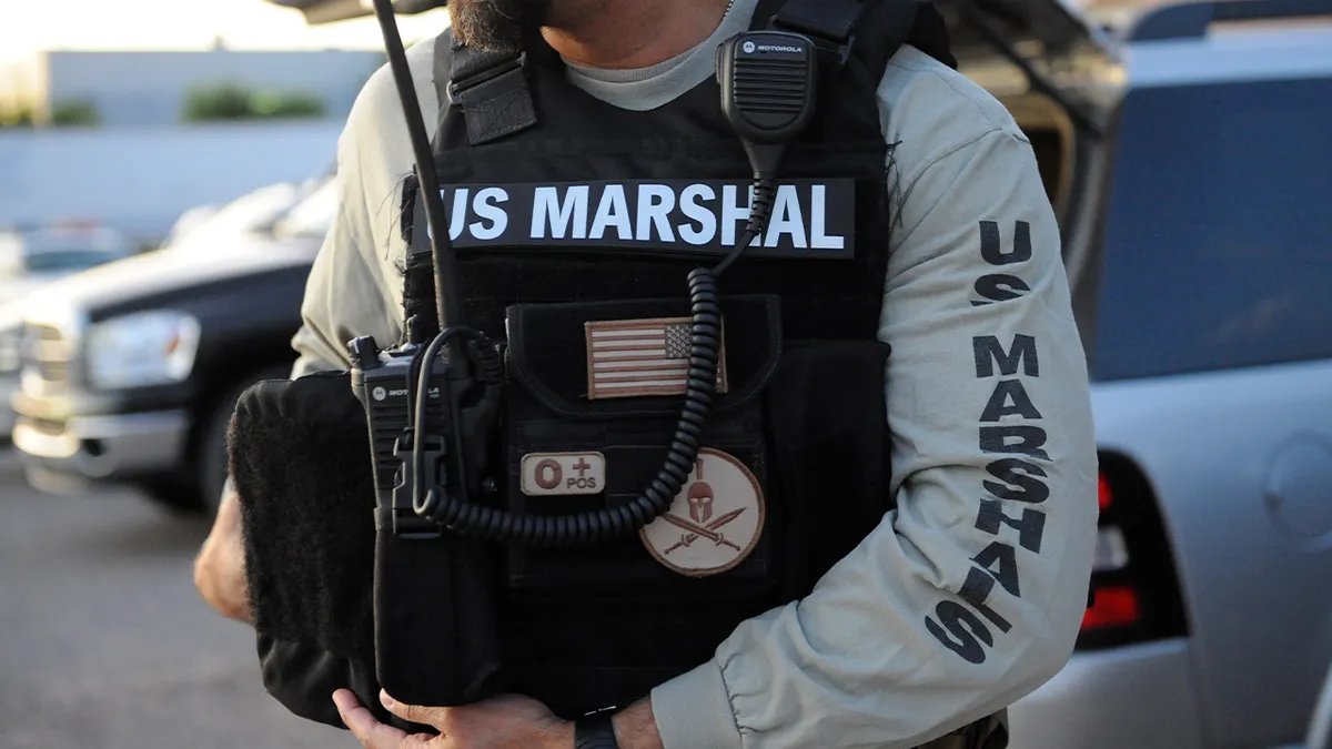 America's Most Wanted's Ronald Fisher Captured on a Sailing Boat in New Jersey 15 Deputy US Marshals Service wearing tactical gear and inscription vest
