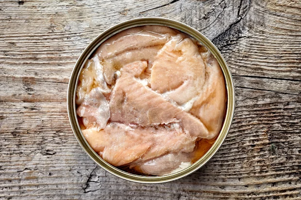 Sardine shortage: With sardines missing from shelves, what are the best canned fish? 23 Opened tin can, canned salmon, on wooden background, top view