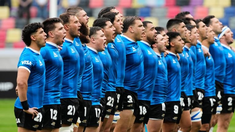 Argentina players sing the national anthem while wearing a commemorative jersey inspired by the one worn by Argentina during their quarter-final victory over England at the 1986 World Cup, before the Rugby Nations Championship match between Argentina and England in Santiago del Estero, Argentina, Saturday, July 18, 2026. (AP Photo/Gustavo Garello)