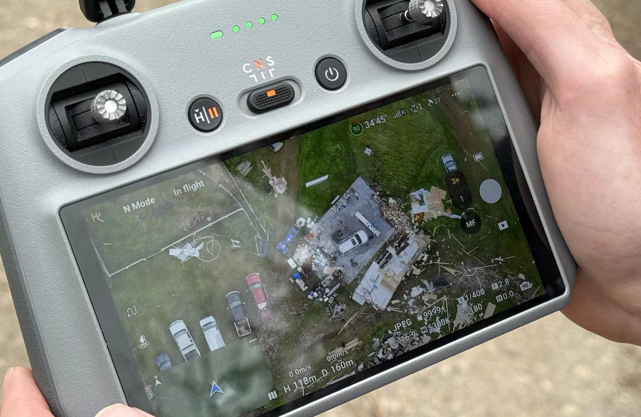 The viewfinder shows drone footage of a house damaged by a tornado.