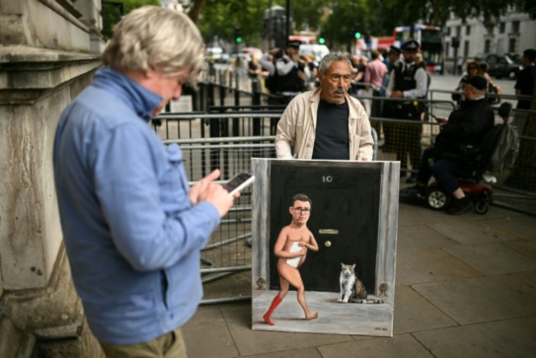 UK: Andy Burnham replaced Keir Starmer at Downing Street - 07/20/2026, 11:33 17 Cartoonist Kaya Mar shows off a painting of a satire of new British Prime Minister Andy Burnham and
