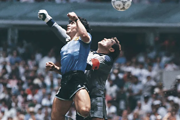 Diego Maradona puts the ball into the net for his 