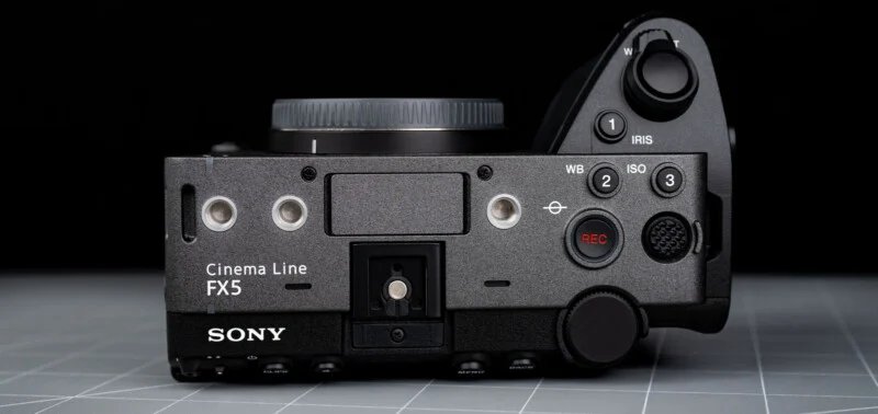 Sony FX5 has a new sensor, open shutter, internal RAW and more 26 Top view of the Sony Cinema Line FX5 camera body: control buttons, dials, record button and lens mount all on a gray mesh surface on a black background.