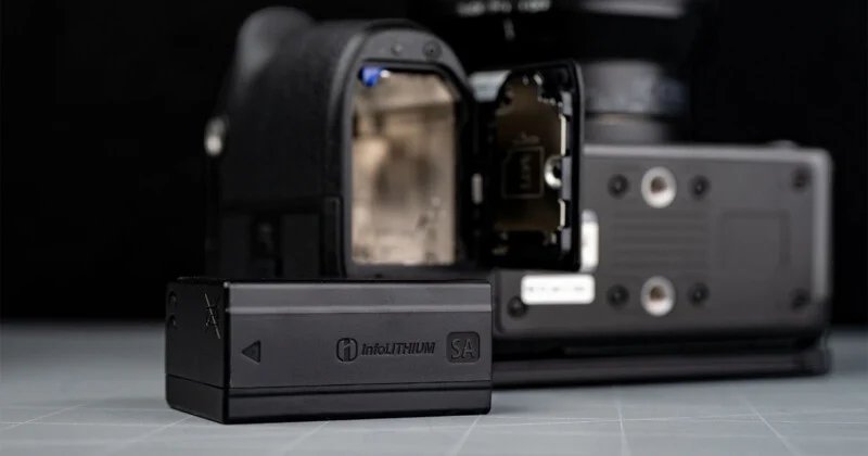 Sony FX5 has a new sensor, open shutter, internal RAW and more 31 In the background is a camera with an open battery compartment, and in the foreground a black InfoLITHIUM battery lies on a flat surface.