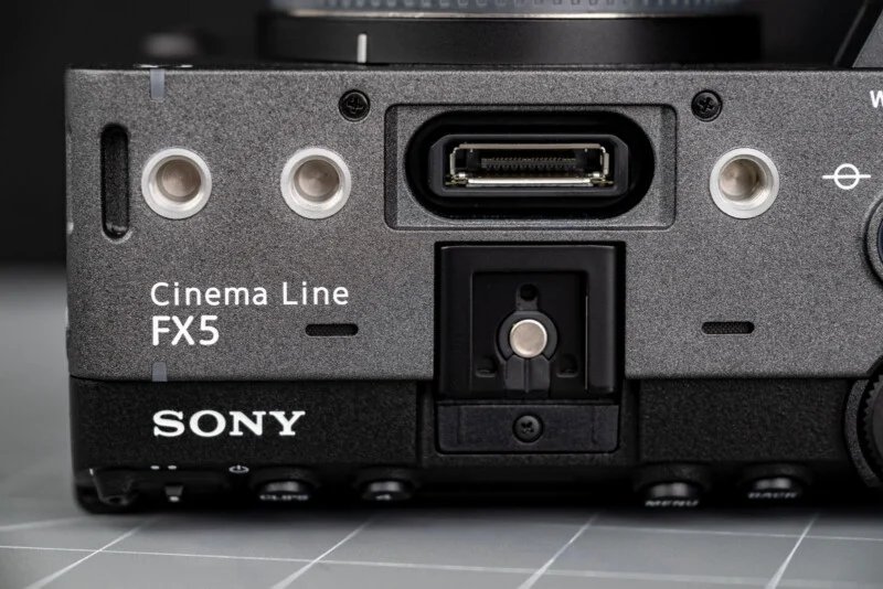 Sony FX5 has a new sensor, open shutter, internal RAW and more 27 Close-up of the Sony Cinema Line FX5 camera body: connection ports and mounting points on a gray surface.